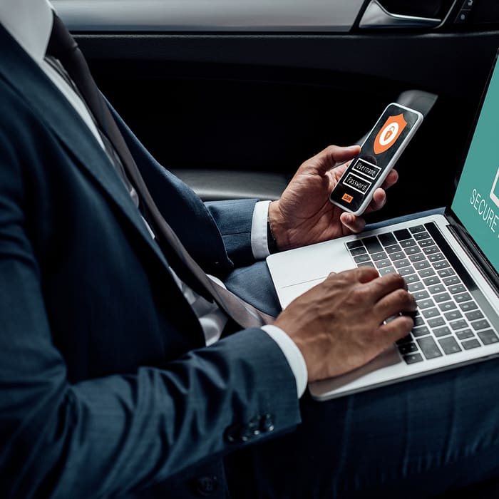 cropped-view-of-african-american-businessman-using-laptop-and-smartphone-in-car-with-cyber-security